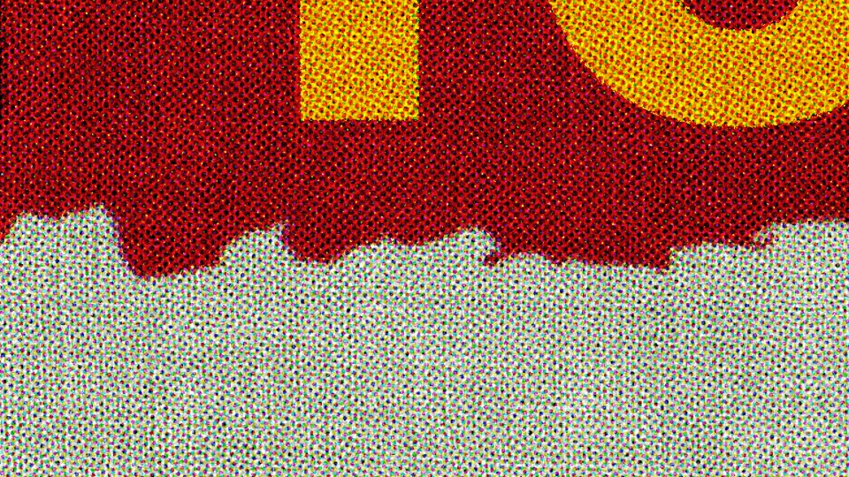 The torn red band over the paper, with Halftone, very close